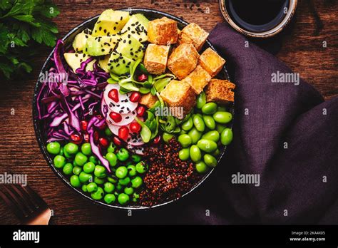 Vegan Vegetarian Buddha Bowl With Quinoa Fried Tofu Avocado Edamame Beans Peas Radish Red