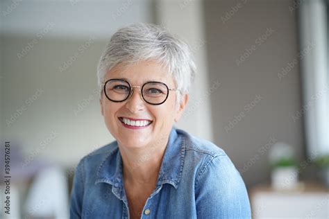 Portrait Of A Beautiful Smiling 50 Year Old Woman With White Hair Stock