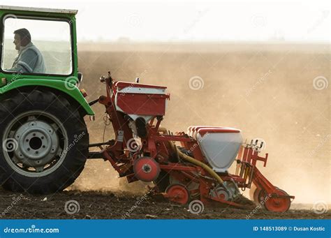 Farmer With Tractor Seeding Soy Crops At Agricultural Field Editorial