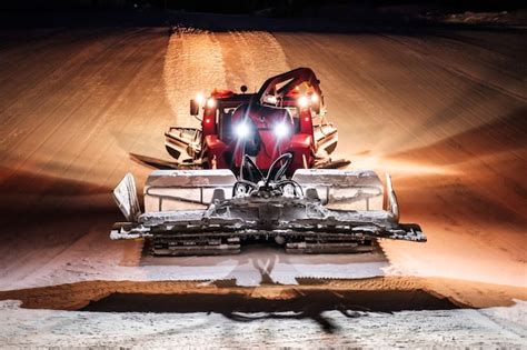 Premium Photo Snowcat Ratrack Machine Making Night Snow Performance