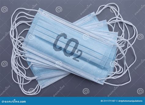 A Stack Of Medical Blue Masks With A Carbon Dioxide Formula On A Gray