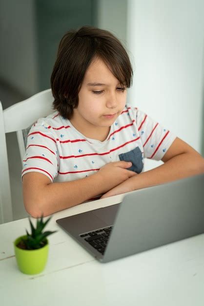 Premium Photo Child Using Laptop At Home Indoors