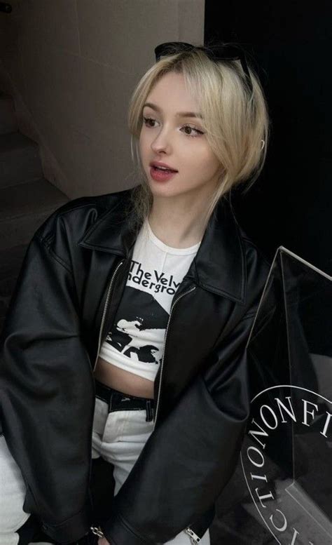 A Woman With Blonde Hair Wearing A Black Leather Jacket