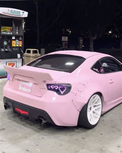 Pink Car parked in front of a Gas Station