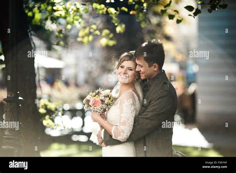 Groom Hugs Bride Stock Photo Alamy