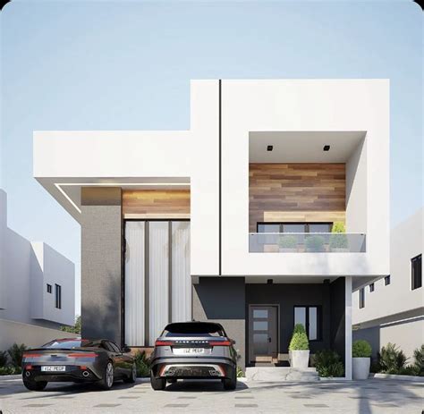 two cars parked in front of a modern house