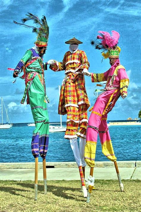 Three Mannequins Dressed In Brightly Colored Clothing Stand On Stils