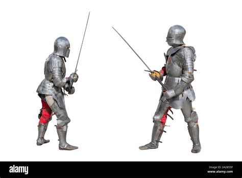 Knights In Armor Medieval Knights In Iron Armor Hold Swords In Their