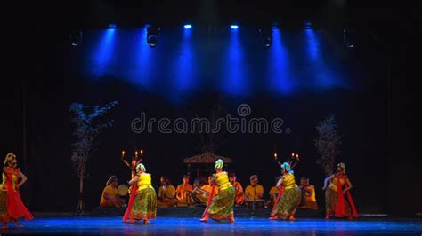 Traditional Dancers On Stage Under Blue Spotlights Performing A