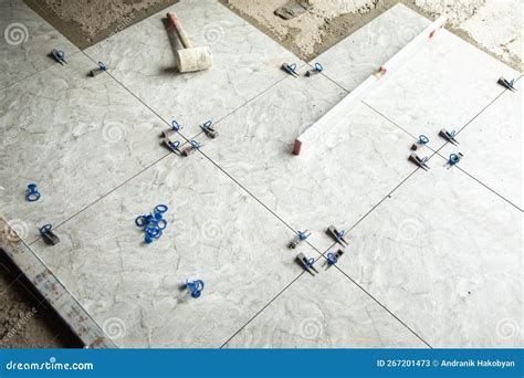 Laying Floor Ceramic Tile. Tools for Renovating Floor Stock Image ...