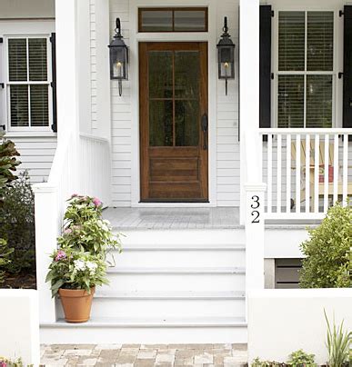 white siding house with wood shutters - Adriane Tang