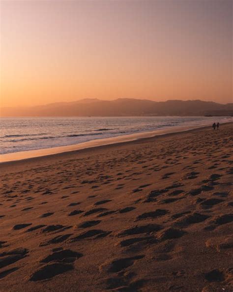 Brown and Black Rock Formations With Fog during Sunset · Free Stock Photo