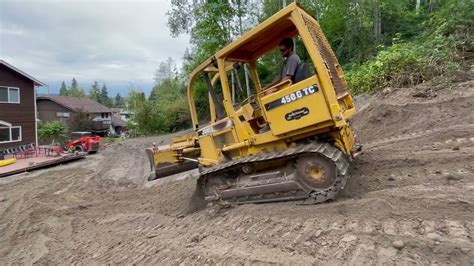 John Deere 450g Tc Dozer Grading A Slope Youtube