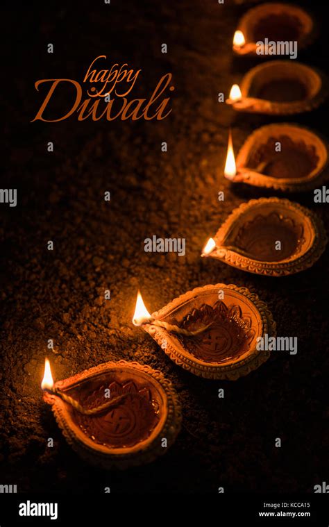 Happy Diwali Greeting Card Design Using Beautiful Clay Diya Lamps Lit