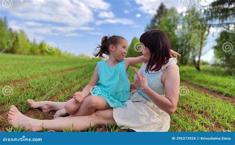 Happy Mother And Daughter Enjoying Rest Playing And Fun On Nature In