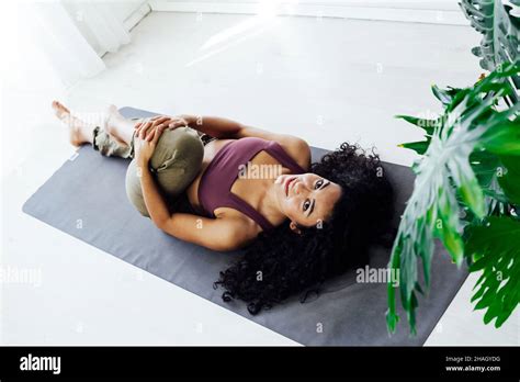 Woman Brunette Doing Exercises Yoga Asana Gymnastics In White Hall