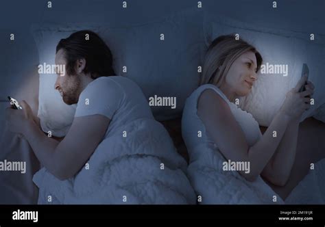 Cheating Concept Husband And Wife Texting On Smartphones Lying Back