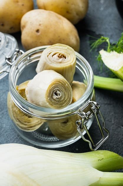 Premium Photo Artichoke Hearts Marinated With Olive Oil On Grey