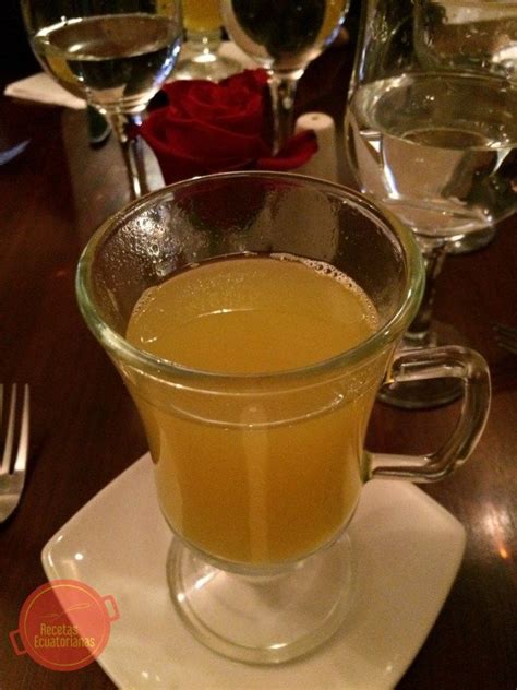 A Glass Filled With Liquid Sitting On Top Of A White Plate