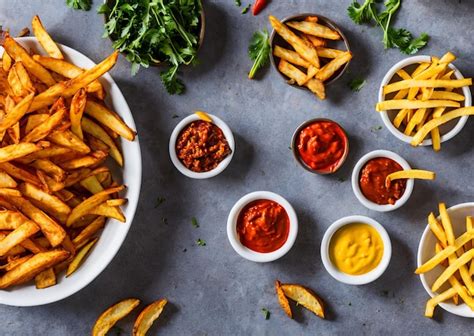 Premium Photo | A plate of fries and ketchup next to a plate of ketchup ...