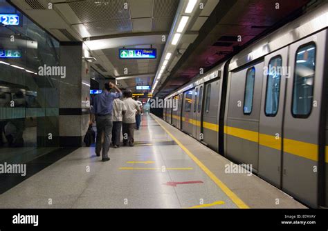 A Yellow Line Train At The Platform And Some Passengers At Chandni