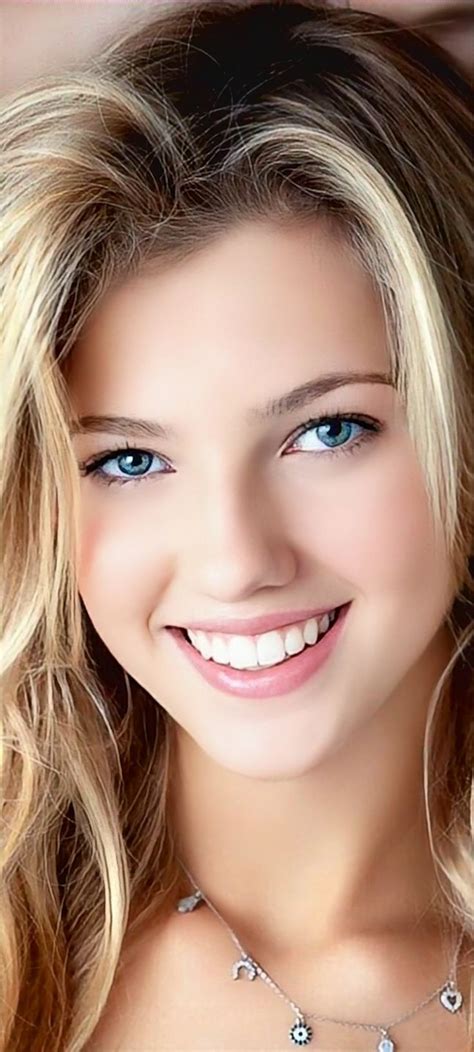 A Beautiful Blond Woman With Blue Eyes And Blonde Hair Smiling At The