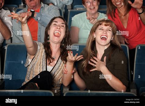 Young Women Laugh Out Loud In Theater Stock Photo Alamy