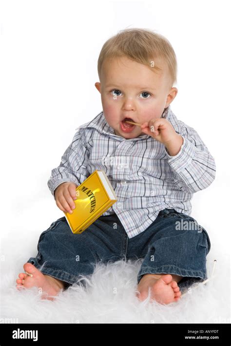 Young baby playing a dangerous game with matches Stock Photo - Alamy