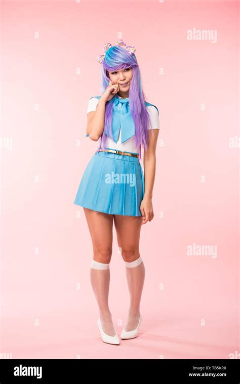 Full Length View Of Otaku Girl In Purple Wig Smiling On Pink Stock