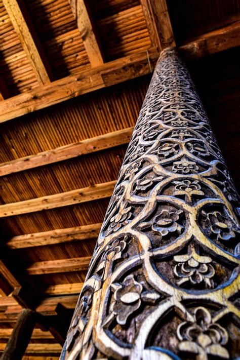 A wooden pillar with intricate designs on it · Free Stock Photo