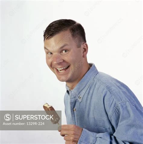 Side Profile Of A Mid Adult Man Holding An Ice Cream Superstock