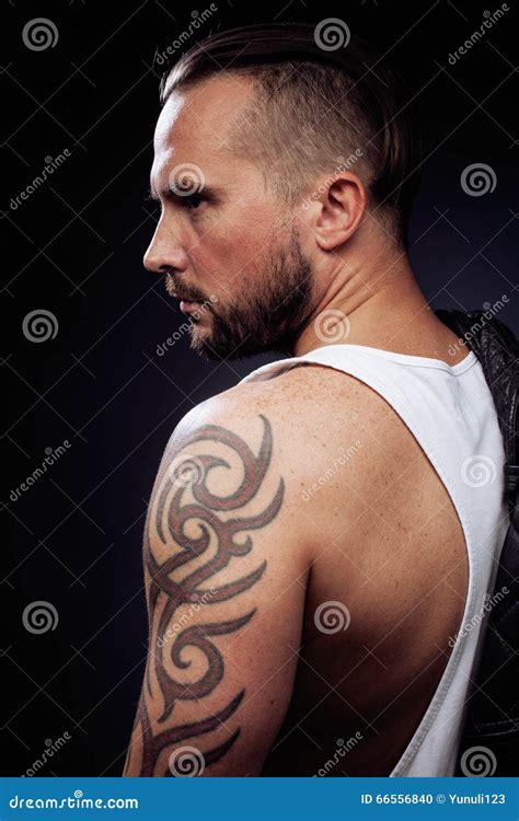 A Man With Tattooes On His Arms Silhouette Of Muscular Body Stock