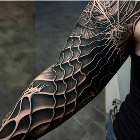 A Man S Arm Is Covered In Black And Grey Ink With An Intricate Design