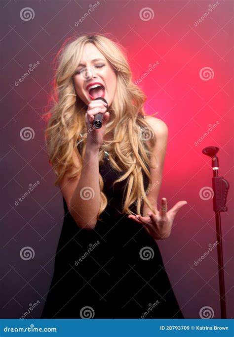 Beautiful Blonde Rock Star On Stage Singing Royalty Free Stock Images