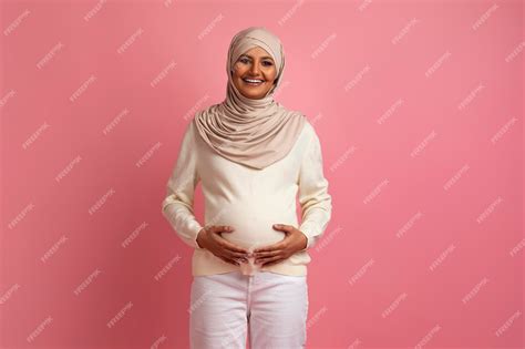 Premium Photo Beautiful Muslim Pregnant Woman Tenderly Embracing