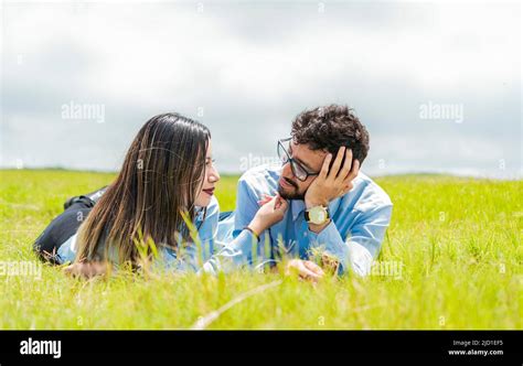 Two People In Love Lying On The Grass Looking At Each Other A Couple