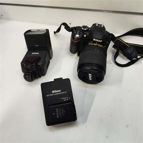 Nikon D3200 with lens and flash attachment (s)