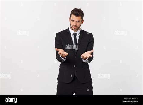 Portrait Of Confident Mature Businessman In Formals Standing Isolated Over White Background