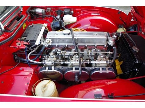 The Engine Compartment Of An Old Red Car