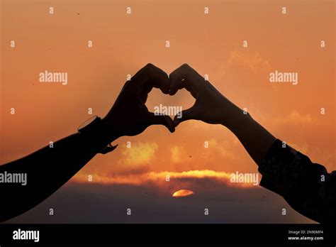 Couple Holding Hands In The Sunset Wallpaper