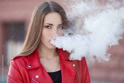 Vaping Young Beautiful Woman Smoking Vaping E Cigarette With Smoke