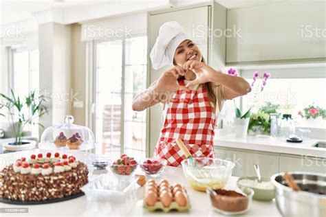 Beautiful Young Brunette Pastry Chef Woman Cooking Pastries At The Kitchen Smiling In Love Doing