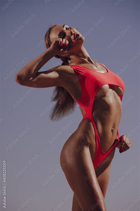 Sexy Hot Woman Posing In Red Bikini Against Sky Background Flash Light