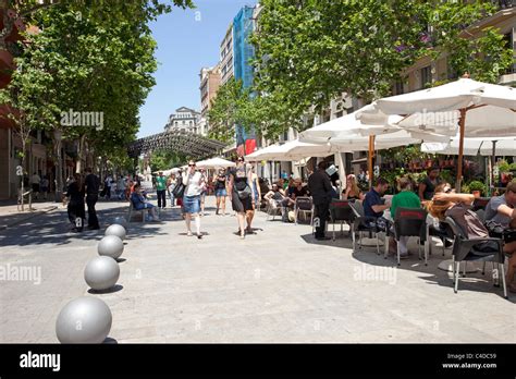 A Sidewalk Cafe In Barcelona Spain With Customers Eating Lunch In The