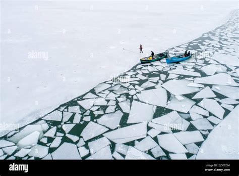 Fishing on frozen lake Stock Photo - Alamy