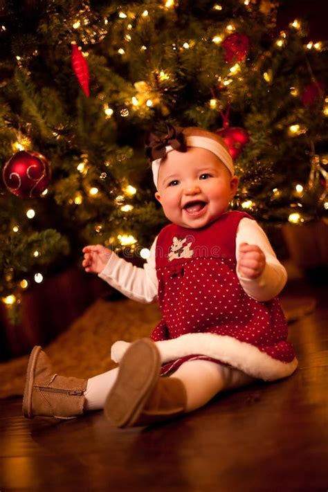 Baby by Christmas Tree stock image. Image of ornaments - 12156091