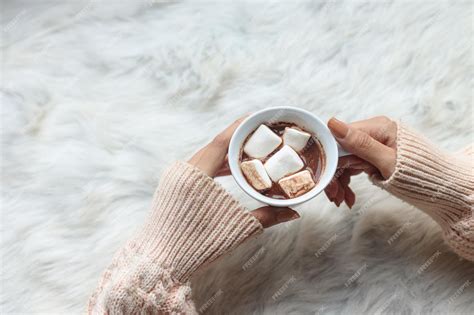 Premium Photo Woman Holding Cacao Mug Filled With Marshmallow In