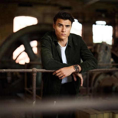 A Man Leaning On A Rail In An Old Factory