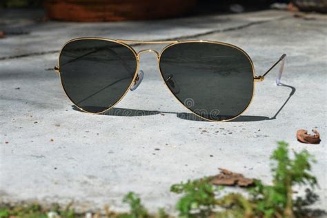 Gold Frame Aviator Black Sunglasses on Floor Stock Image - Image of ...