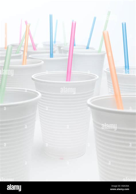 Plastic cups with straws on a white background Stock Photo - Alamy